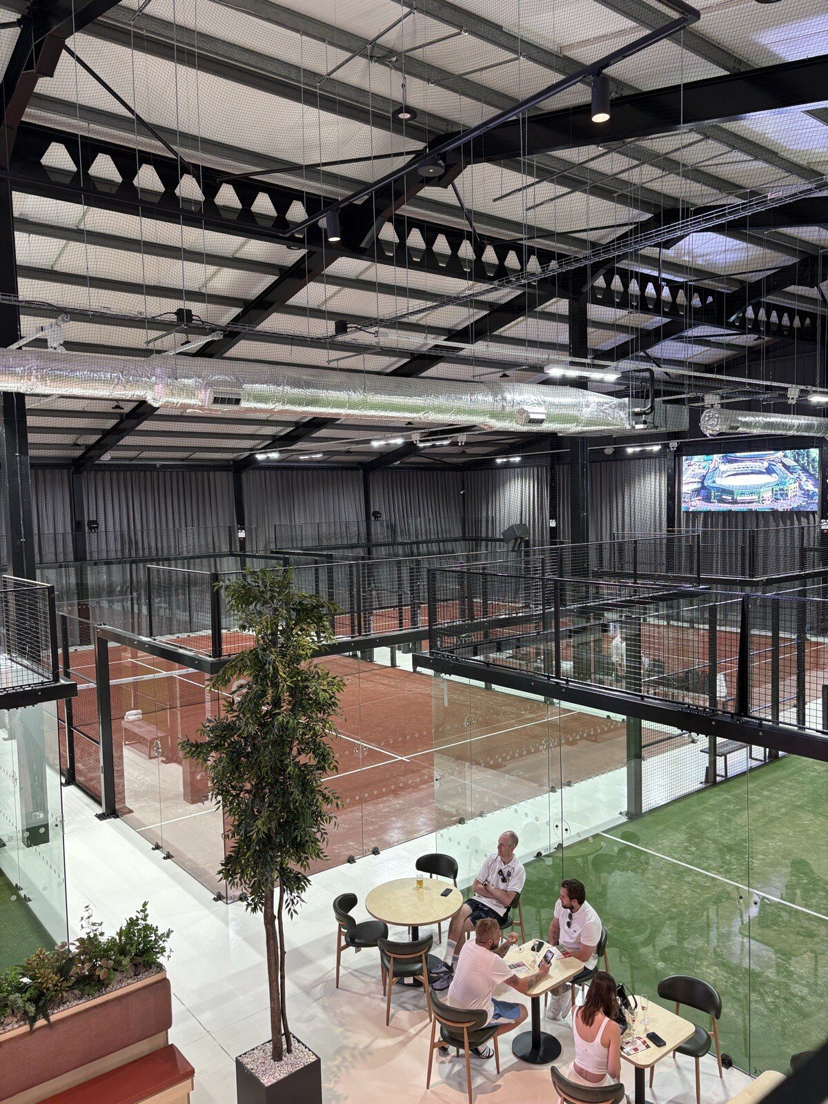 Inside the Encourt Padel and Wellness venue showing padel courts and social areas